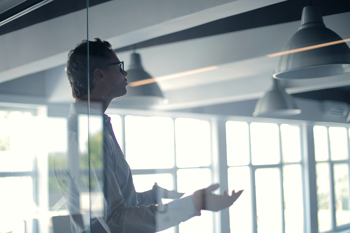 male-employer-gesticulating-and-explaining-idea-in-light-3760089