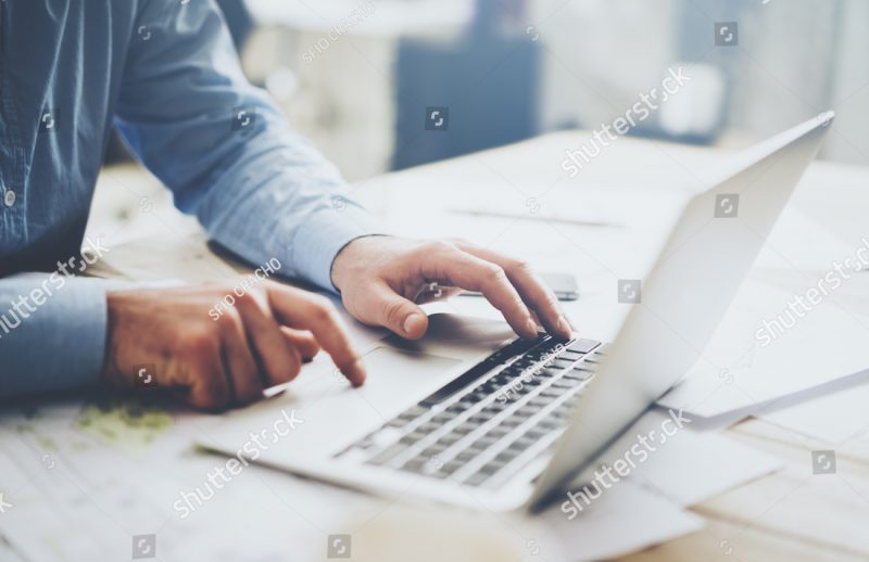 stock-photo-businessman-working-laptop-for-new-architectural-project-generic-design-notebook-on-the-table-380601157
